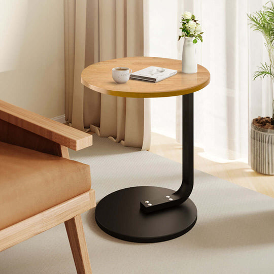 Affordable quality value furniture homewares - Modern round wooden side table with black metal base in a stylish living room setting.