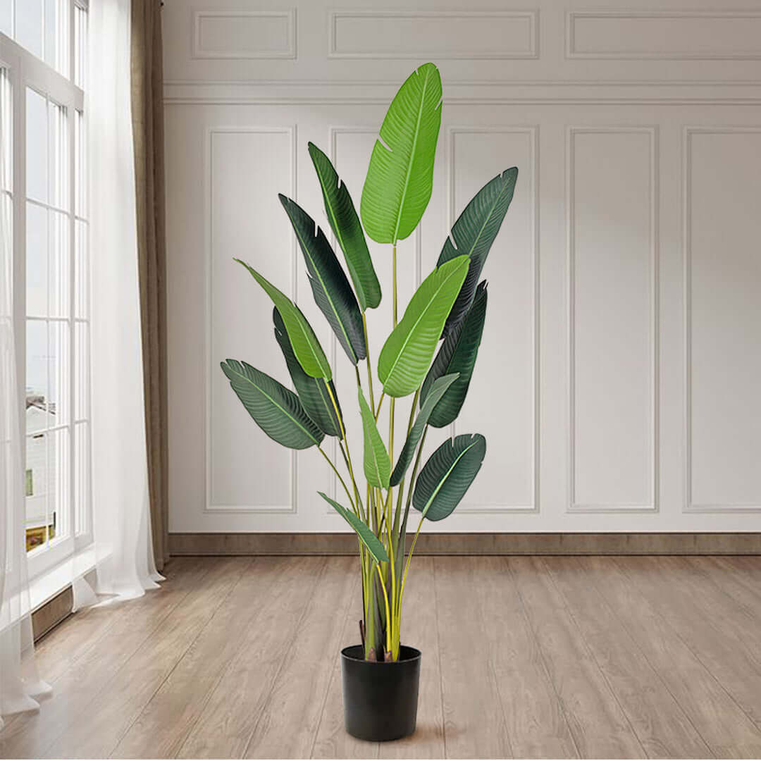 Affordable quality homeware - artificial potted plant standing in elegant room with white paneled walls and hardwood floors.