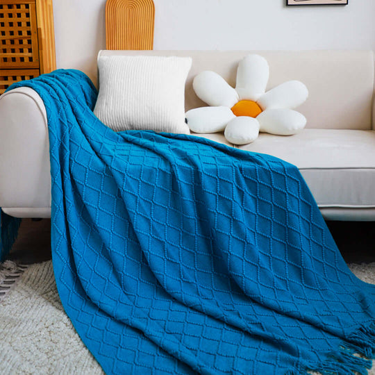 Affordable quality homewares, blue blanket draped over a white couch with value furniture accents