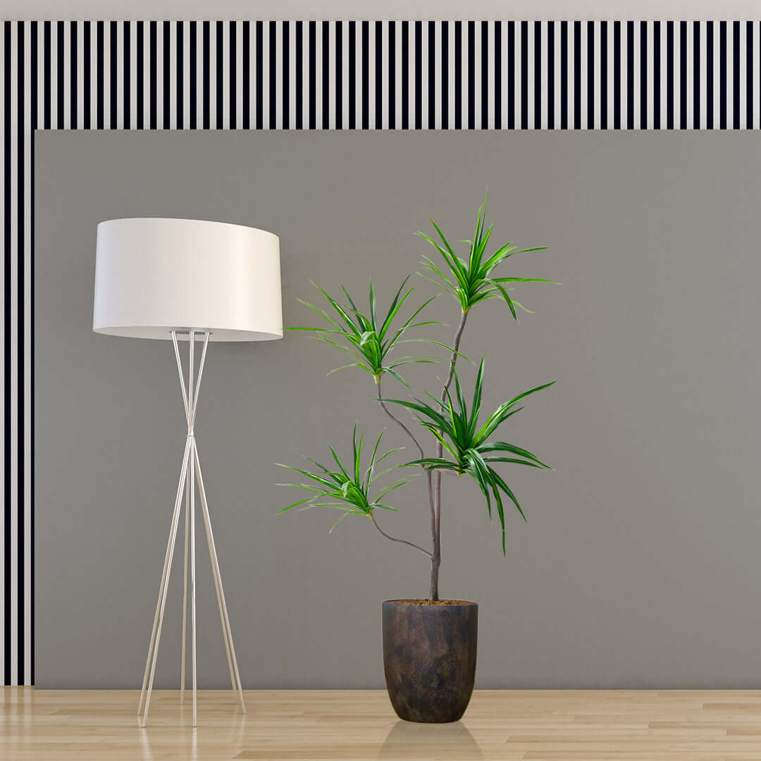 Modern floor lamp and potted plant in stylish living room with gray walls and striped decor, showcasing affordable quality homewares and value furniture.