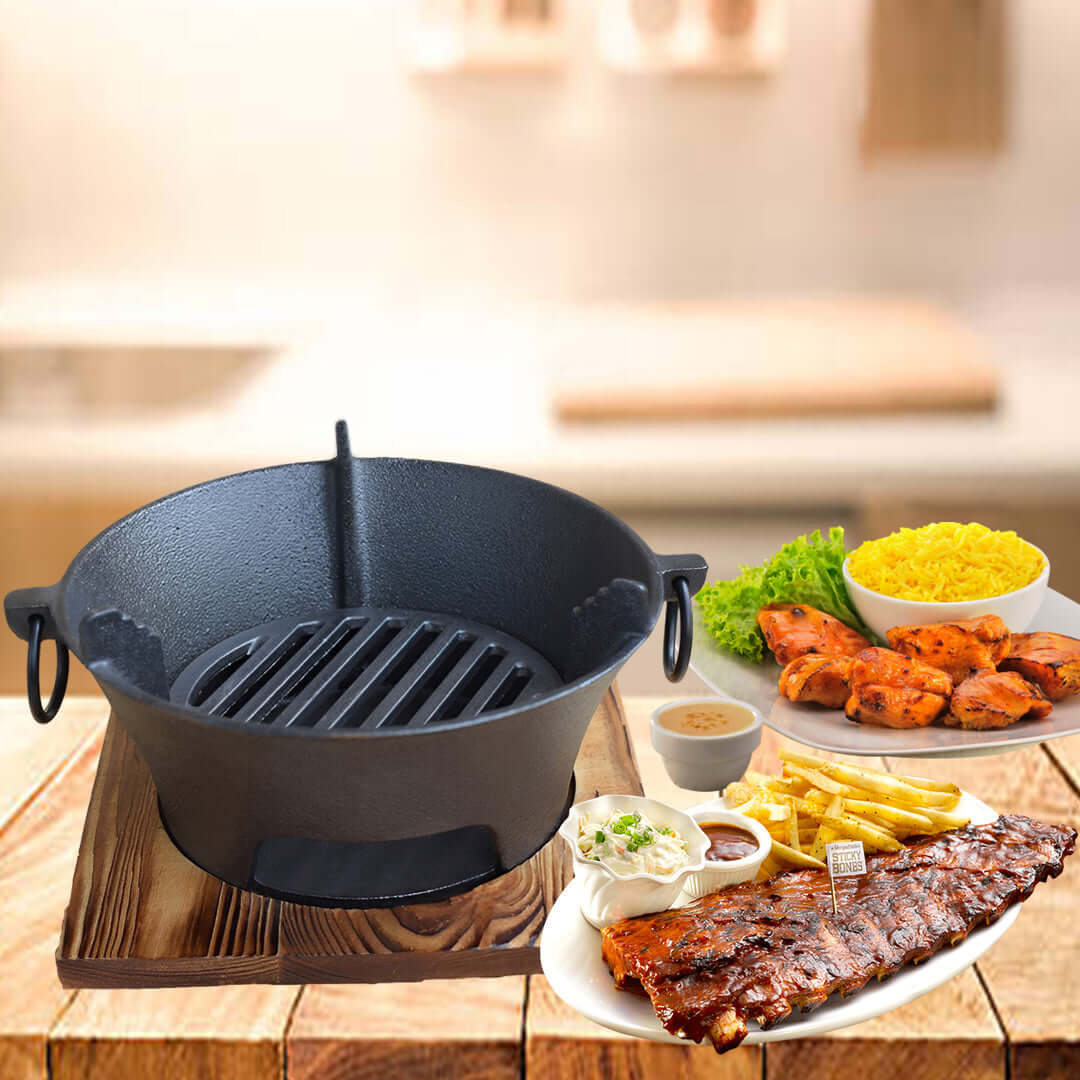 Cast iron cookware with assorted grilled food, including ribs, grilled chicken, fries, and rice in a kitchen setting.