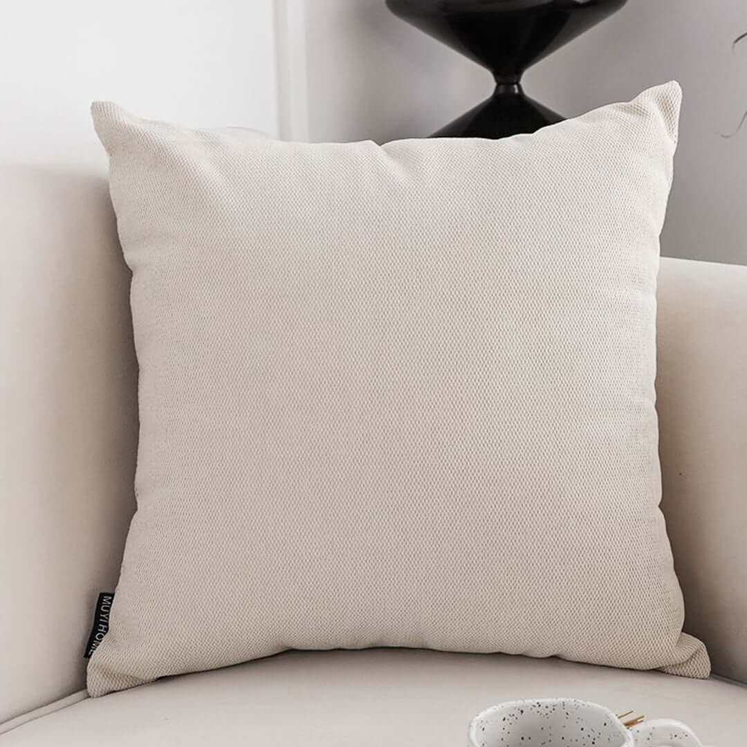 Affordable quality homewares - beige throw pillow on a white couch, excellent value furniture addition.