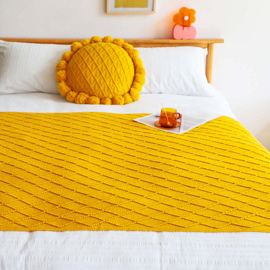 Affordable quality homewares, bright yellow bedding with decorative pillow on cozy bed, value furniture for a stylish and inviting bedroom.