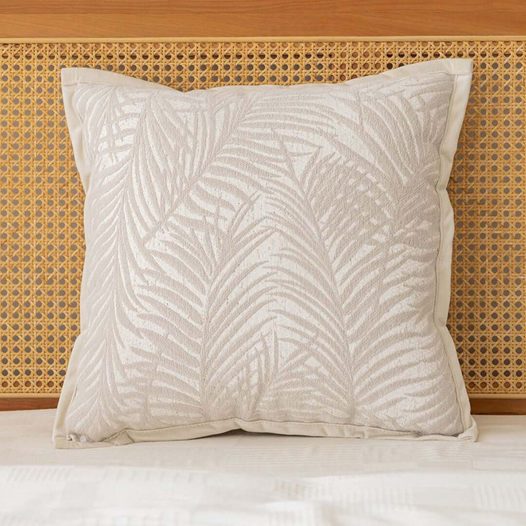 Affordable quality homewares - decorative cushion with leaf pattern on a wooden headboard, value furniture.