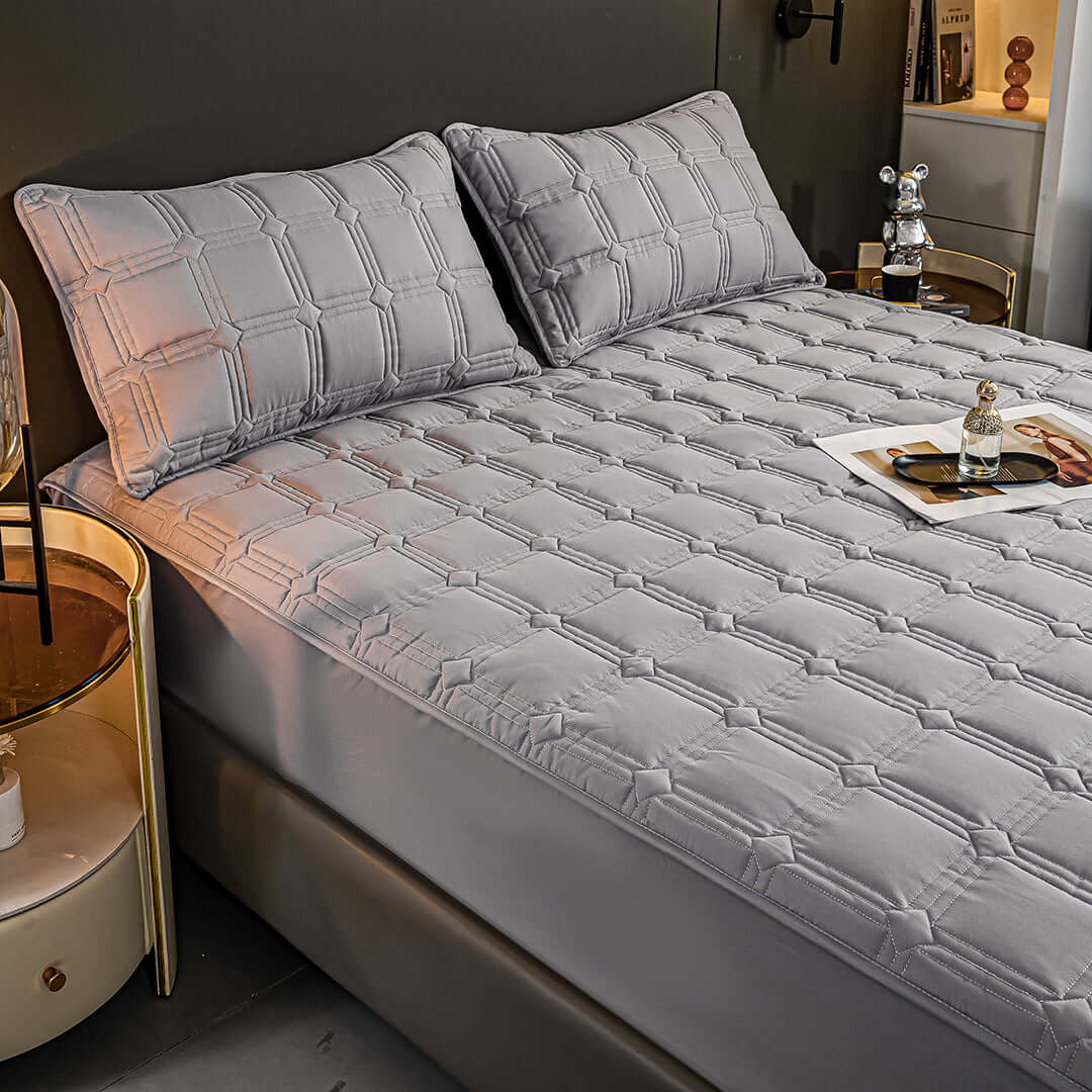 Affordable and quality value furniture - modern gray quilted bed set shown in a stylish contemporary bedroom.