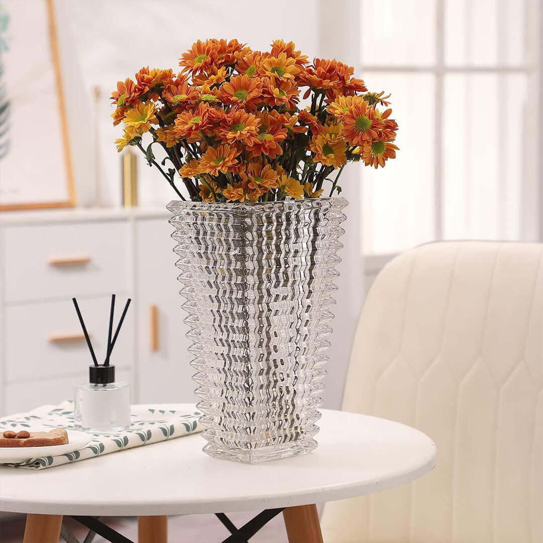 Affordable quality homewares - decorative glass vase with orange flowers on a value furniture table in a well-lit room.