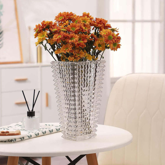 Affordable quality homewares - decorative glass vase with orange flowers on a value furniture table in a well-lit room.