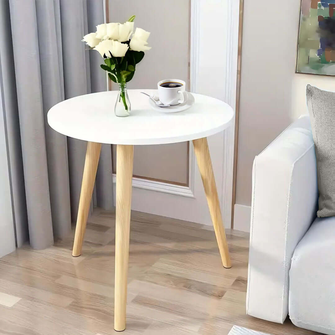 Affordable quality homeware round wooden table with flowers and a coffee cup, stylish value furniture for a modern living room.