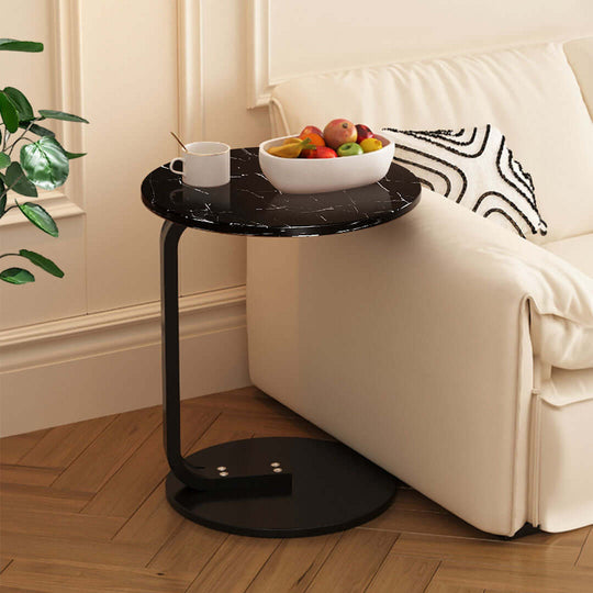 Stylish black side table with marble top holding a fruit bowl and cup in a cozy living room filled with affordable, quality homewares and value furniture.