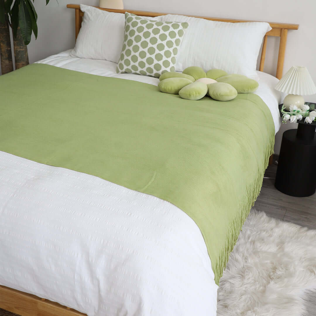 Affordable quality homewares - stylish green and white bedding set with decorative pillows on a wooden bed, providing great value furniture for bedrooms