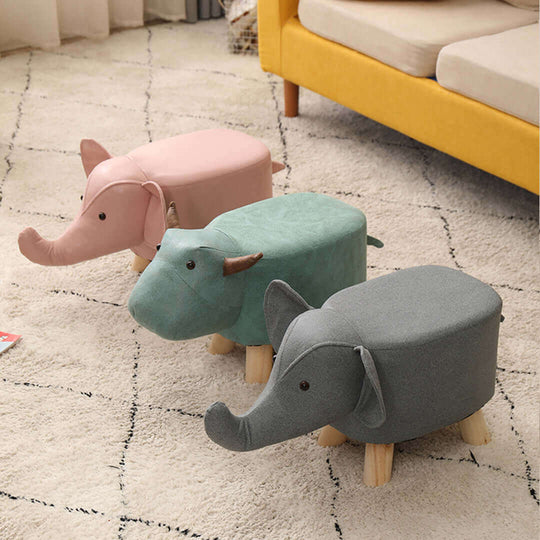 Affordable quality elephant-themed homewares and furniture in pink, green, and grey on a patterned carpet in a cozy living room.