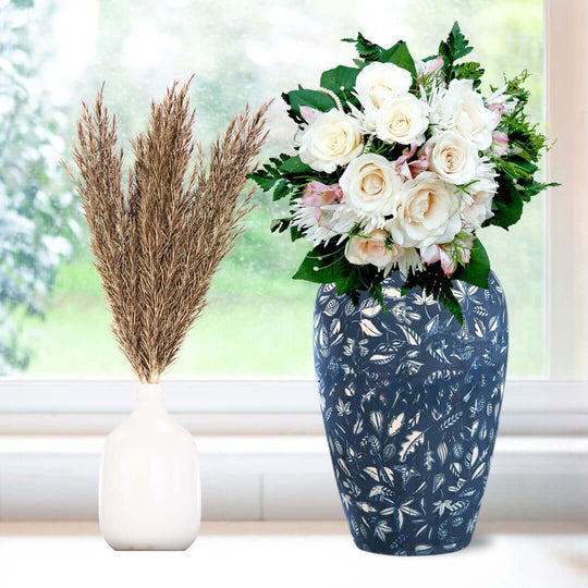 "Affordable quality homewares featuring a navy floral vase with white roses and a minimalist white vase with dried reeds, enhancing value furniture decor"