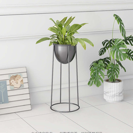 Modern black plant stand with green plants, next to a white ceramic pot and photo frame, showcasing affordable quality homewares and value furniture.