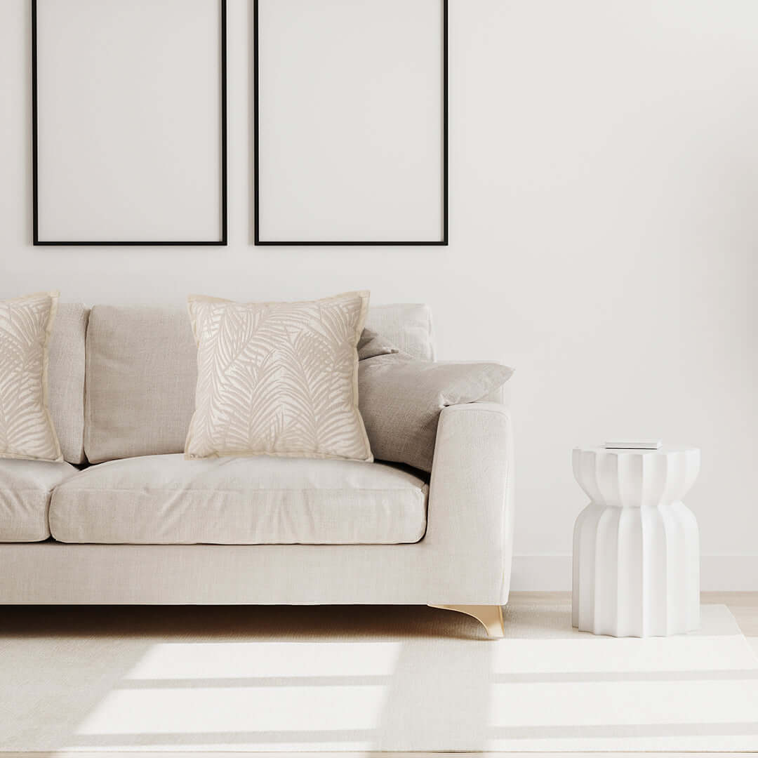 Affordable quality homewares and value furniture - beige sofa with decorative pillows and modern white side table in a bright minimalistic living room