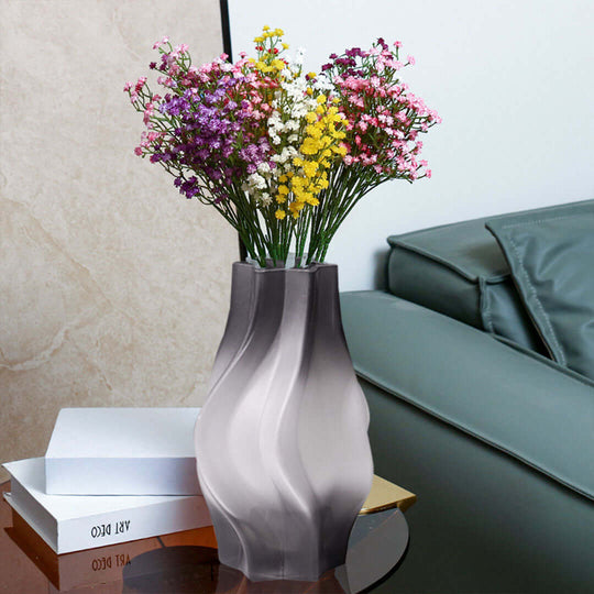 Affordable homewares - vibrant flowers in quality, sleek gray vase on modern stylish table for added value to furniture decor.