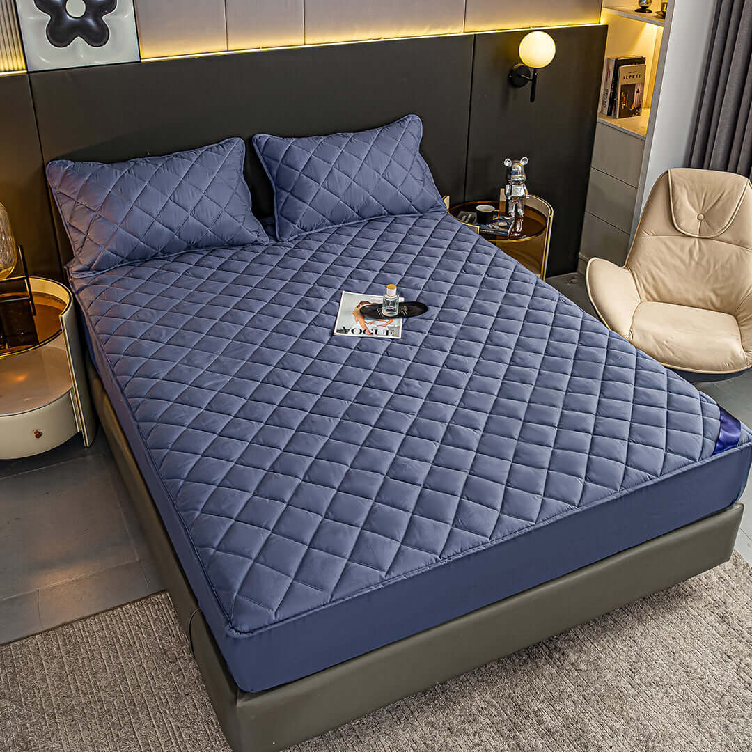 Affordable quality homewares - comfortable bed with blue quilted bedding set and pillows in a modern, stylish bedroom.