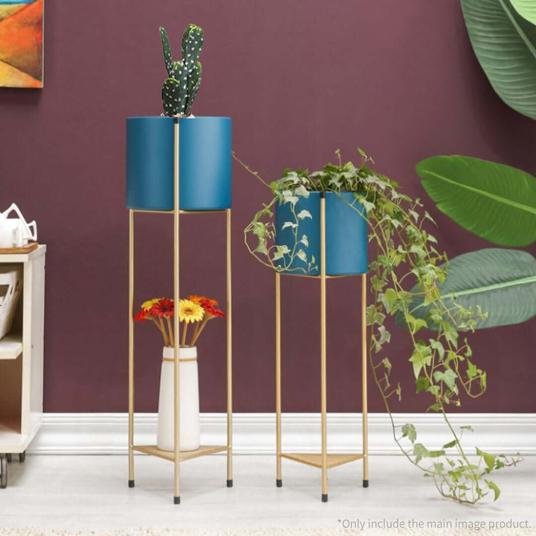 Stylish affordable homewares with quality value furniture, featuring blue planters on gold stands against a burgundy wall.