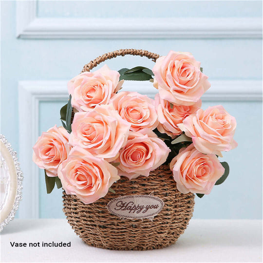 Basket of pink roses on display in front of a light blue background with a "Happy You" label, vase not included.