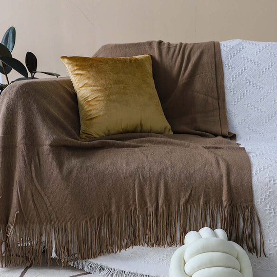 Brown and white throw blanket with a mustard cushion on a cozy sofa, affordable homewares showcasing quality and value furniture.