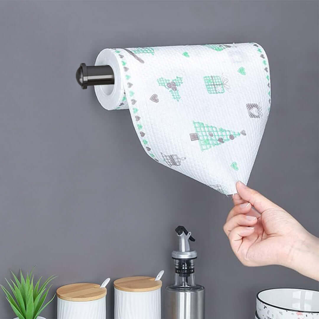 Hand pulling a paper towel from a roll mounted on a wall, ideal for affordable homewares with quality and value furniture.