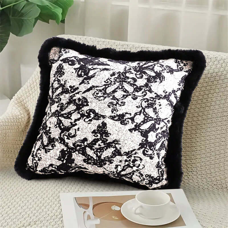 Elegant affordable homewares - black and white decorative pillow on a couch highlighting quality and value furniture.