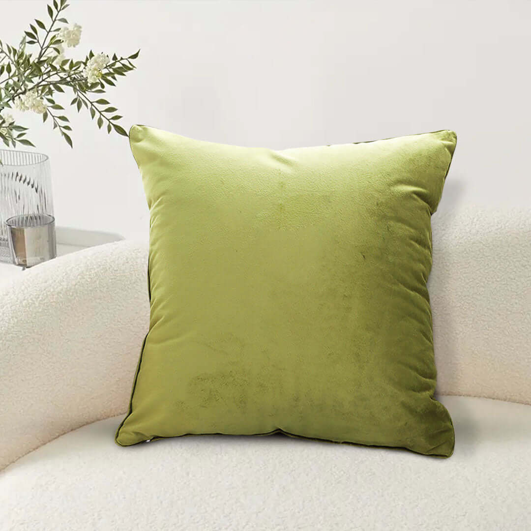 Affordable and quality green velvet throw pillow on a cream sofa, providing value homewares and stylish furniture accents.