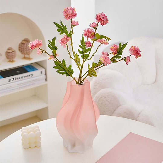 Pink ceramic vase with artificial pink flowers on a white table, showcasing affordable quality homewares and value furniture.