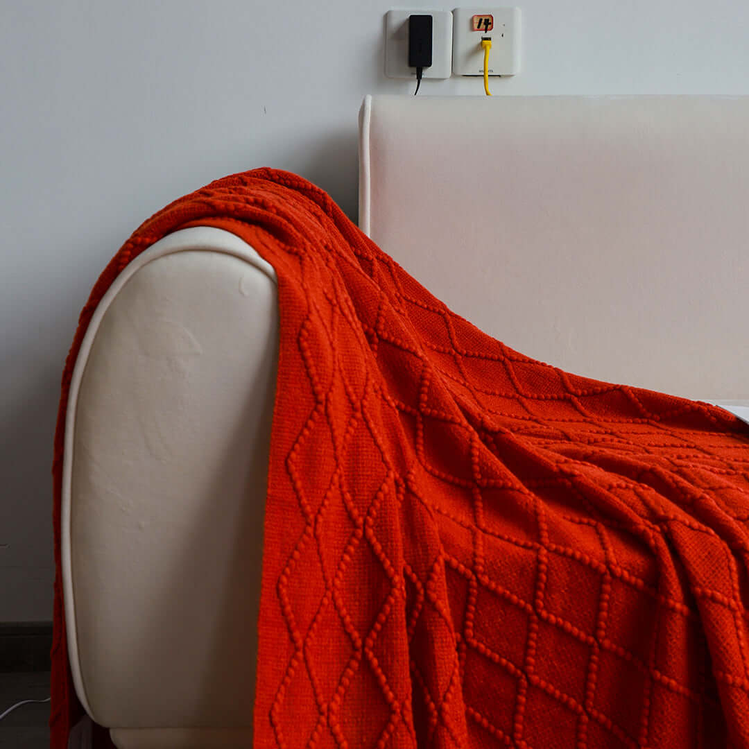 Affordable quality homewares - vibrant red blanket draped over off-white sofa offering value furniture solutions.