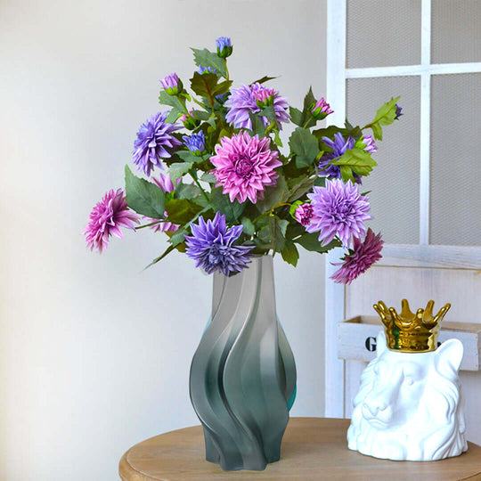 Elegant flower arrangement in a modern vase on wooden table. Affordable homewares offering quality, value furniture.