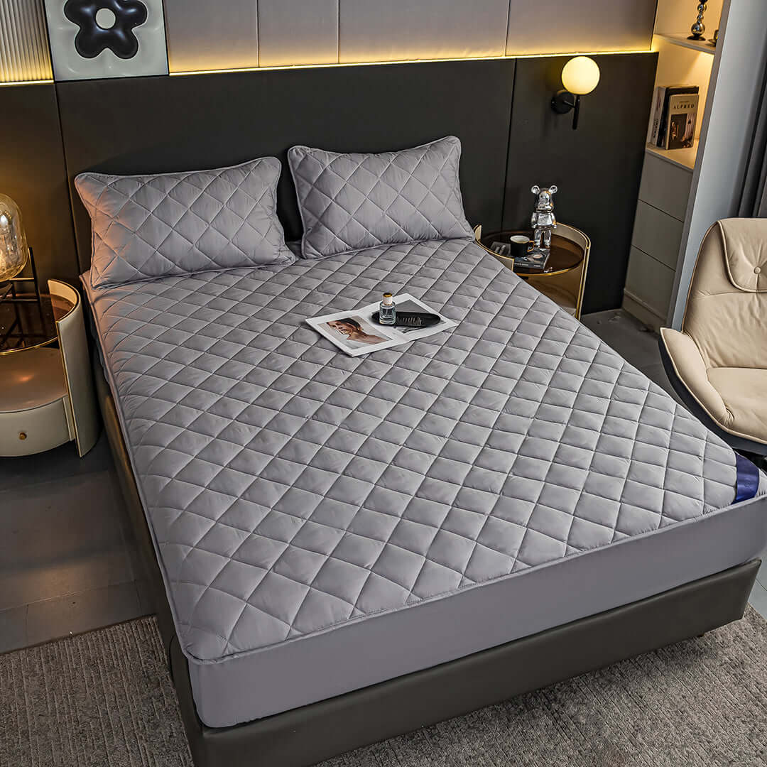 Affordable quality value homewares - Modern bedroom setup with a gray quilted bedspread and stylish decor.