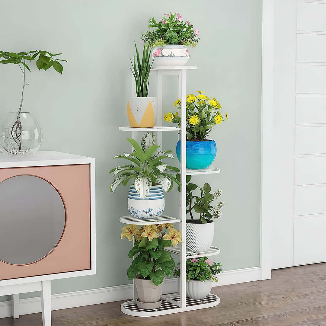 Affordable quality homewares - white tiered plant stand with vibrant potted plants, showcasing value furniture in a modern home setting.