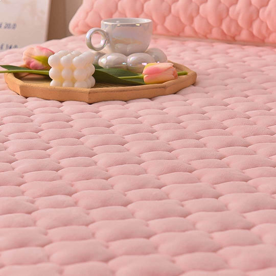 Cozy pink quilted bedding with tea cup on wooden tray surrounded by flowers, showcasing affordable quality homewares and value furniture.