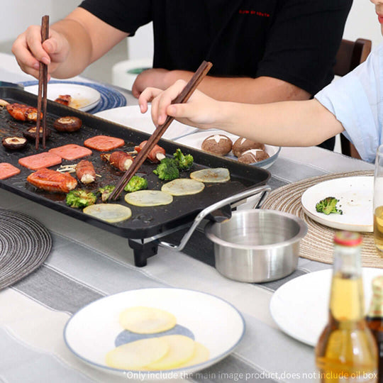 Two people cooking vegetables and meat on an electric grill at home, showcasing quality and affordable value homewares.