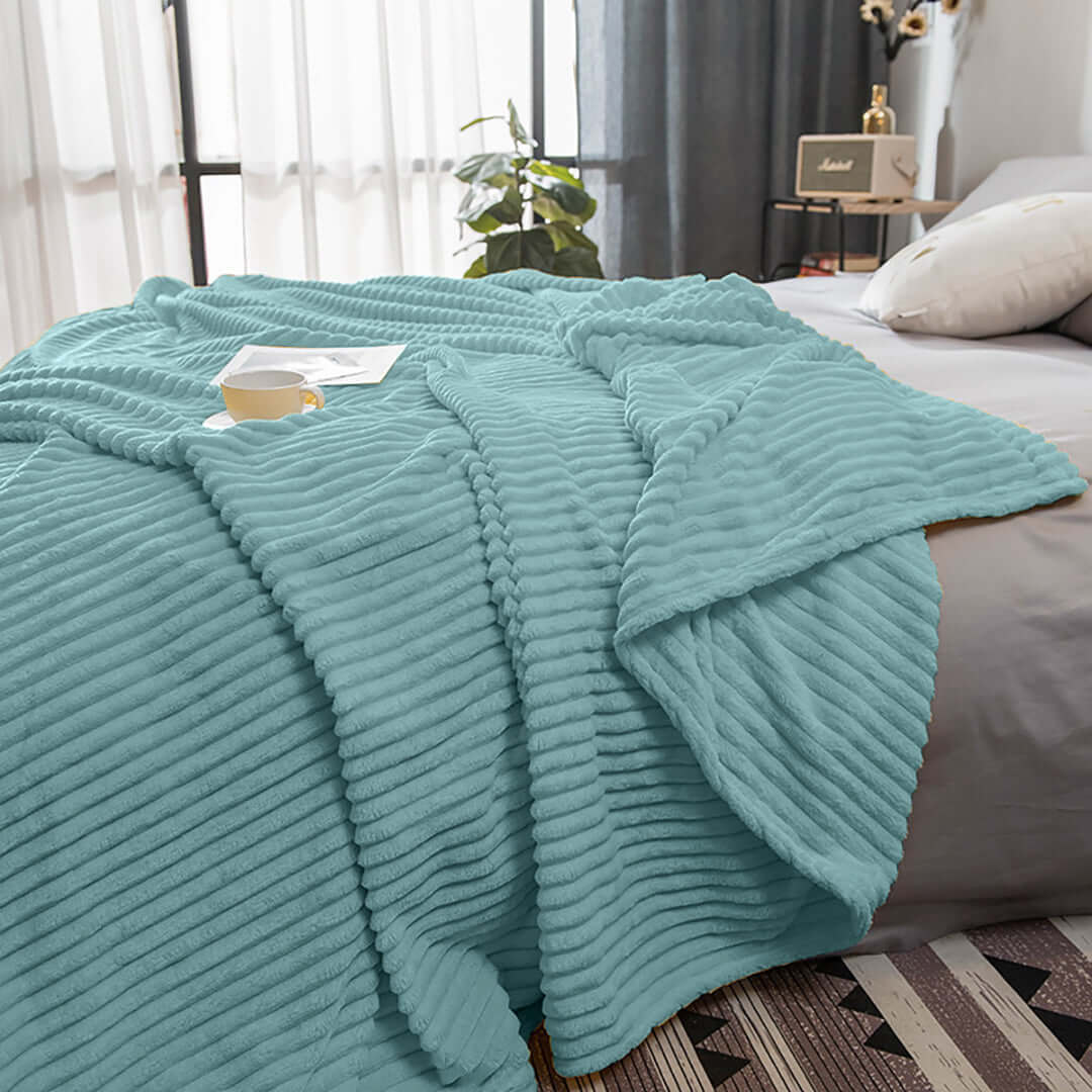 Affordable quality teal blanket on bed in cozy, stylish home with value furniture in background