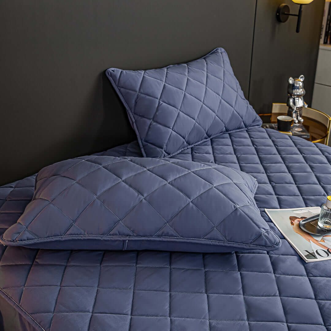 Affordable quality homewares - stylish blue diamond-patterned pillow and matching bedding on a value furniture setup.