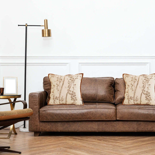 Affordable homewares and quality value furniture - stylish brown leather sofa with decorative pillows in a modern living room setting.