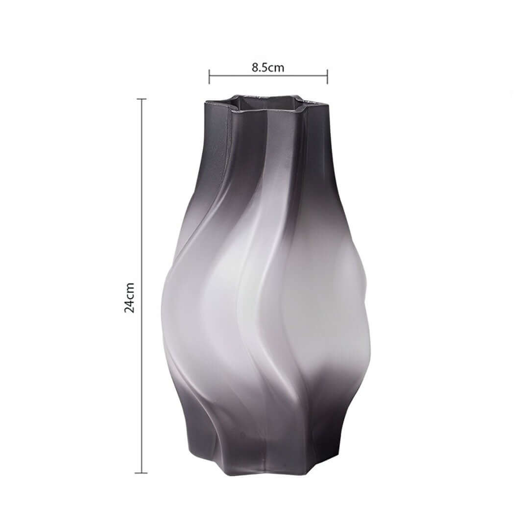 Sleek black and white vase with curved design measuring 24cm in height and 8.5cm in width, perfect for adding quality value to affordable homewares.