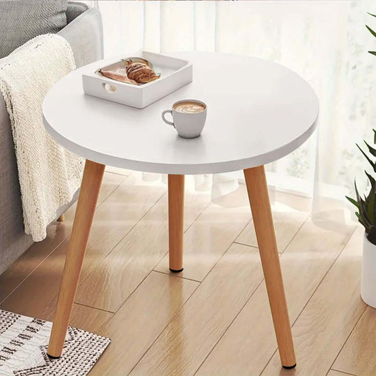 Modern round white table with wooden legs, featuring a coffee cup and tray with pastries, showcasing affordable, quality homewares and value furniture.