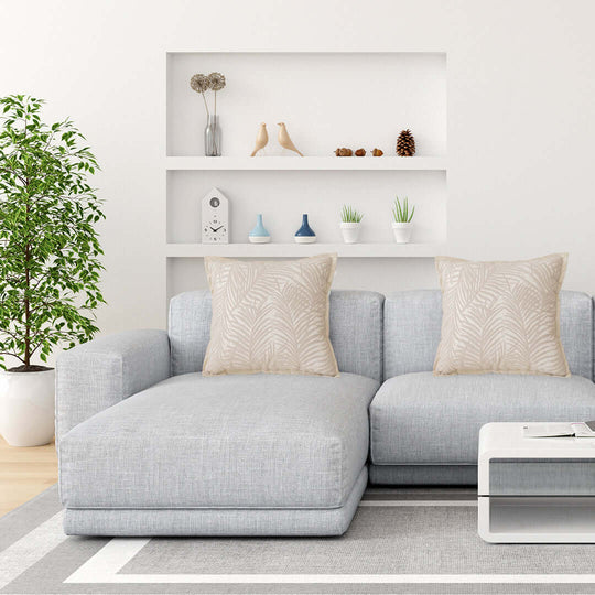 Affordable quality value furniture - modern grey sofa with decorative cushions in a stylish living room with homewares and indoor plant.