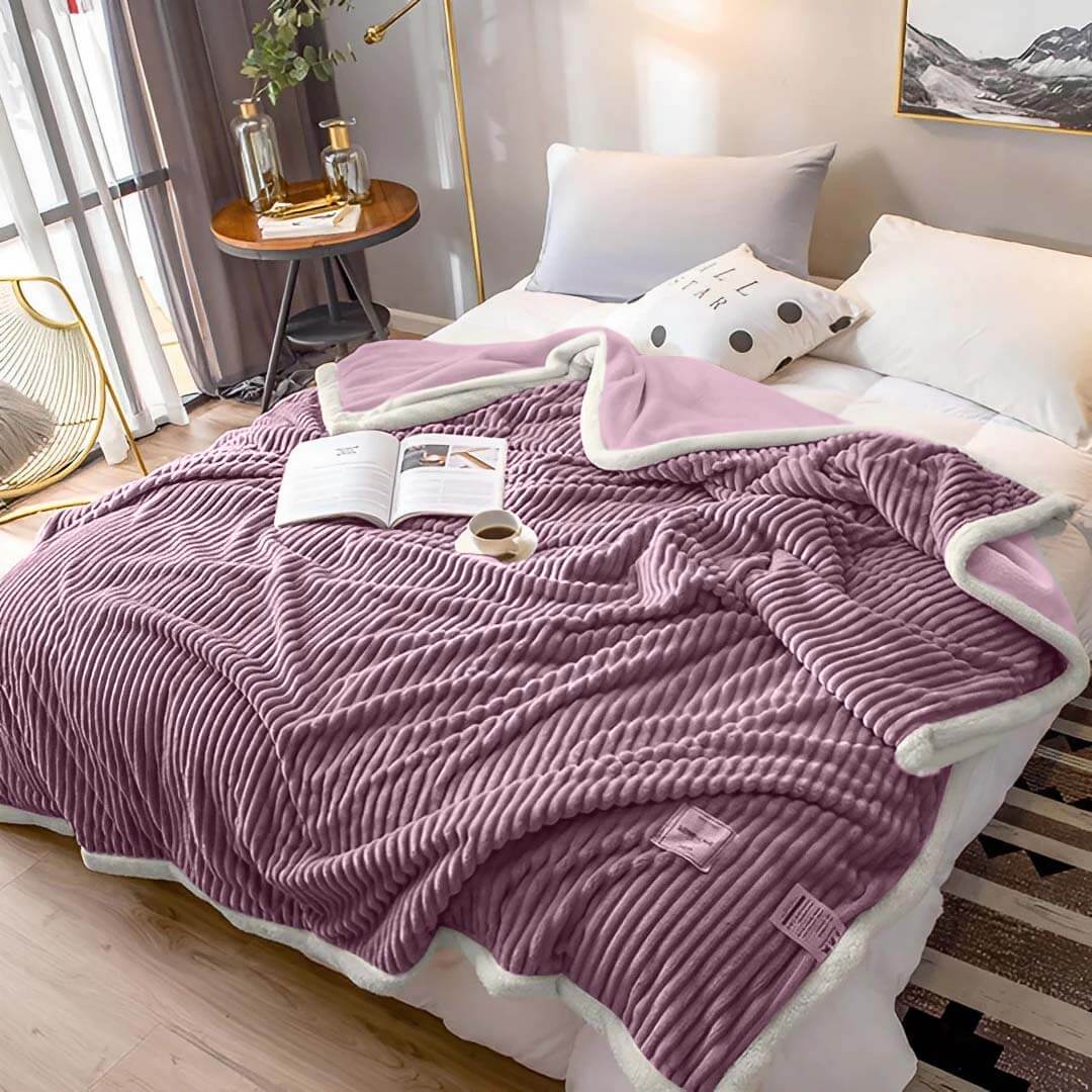 Luxurious, cozy purple blanket on a neatly made bed in a stylish bedroom with quality and affordable homewares.