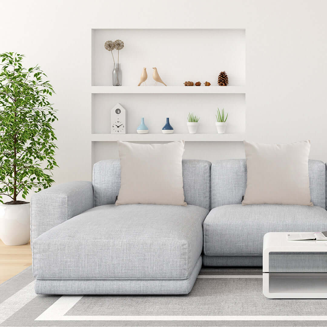 Affordable quality value furniture - stylish homewares grey sectional sofa with neutral cushions in a modern living room setup.