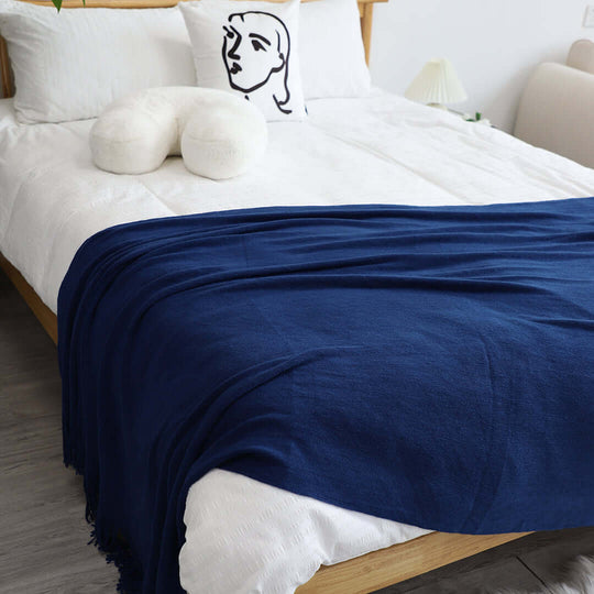 Comfortable bed with blue blanket, white pillow and art cushion, offering affordable and quality homewares for value furniture.