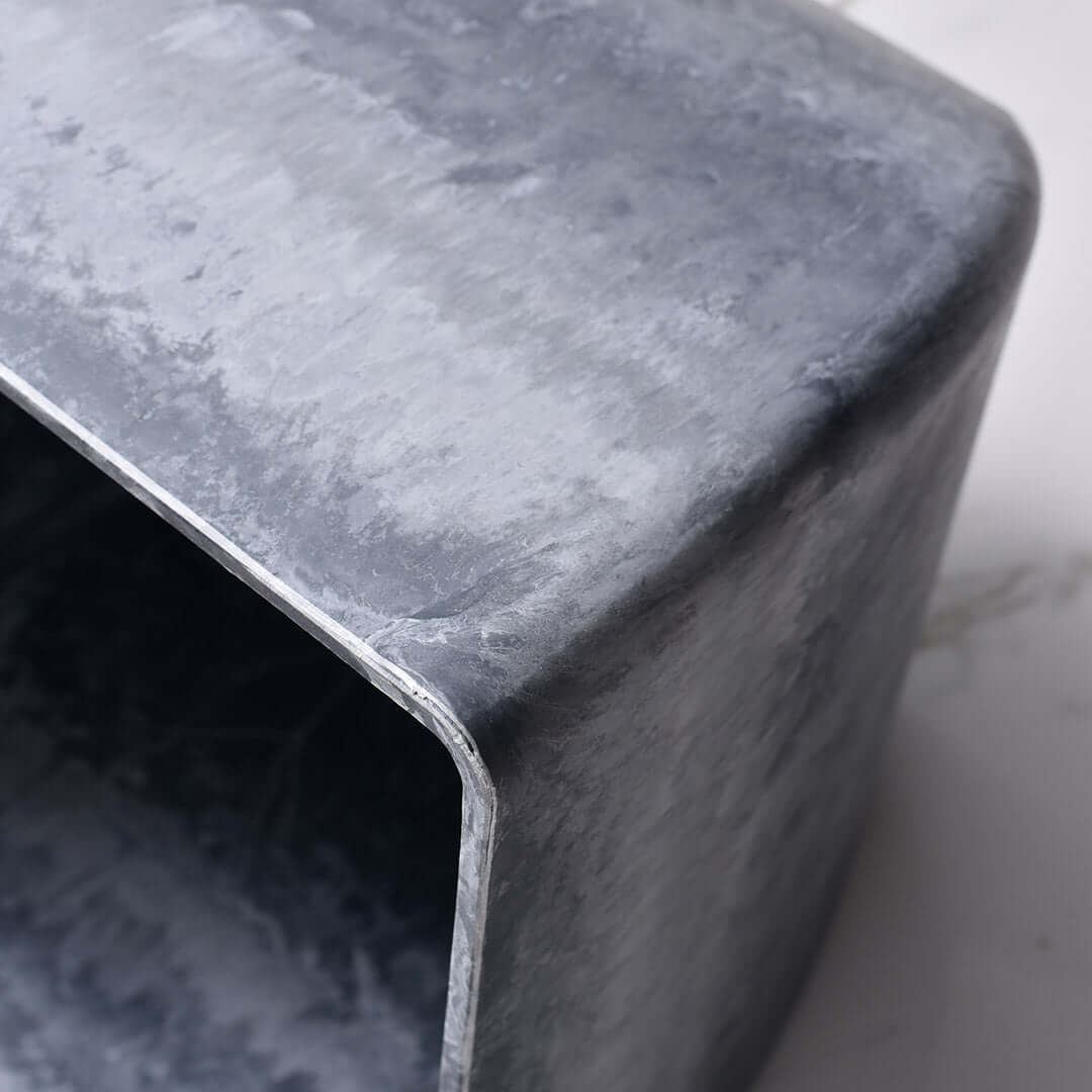 Close-up of a modern, affordable, grey concrete homeware piece, emphasizing quality craftsmanship and value furniture.