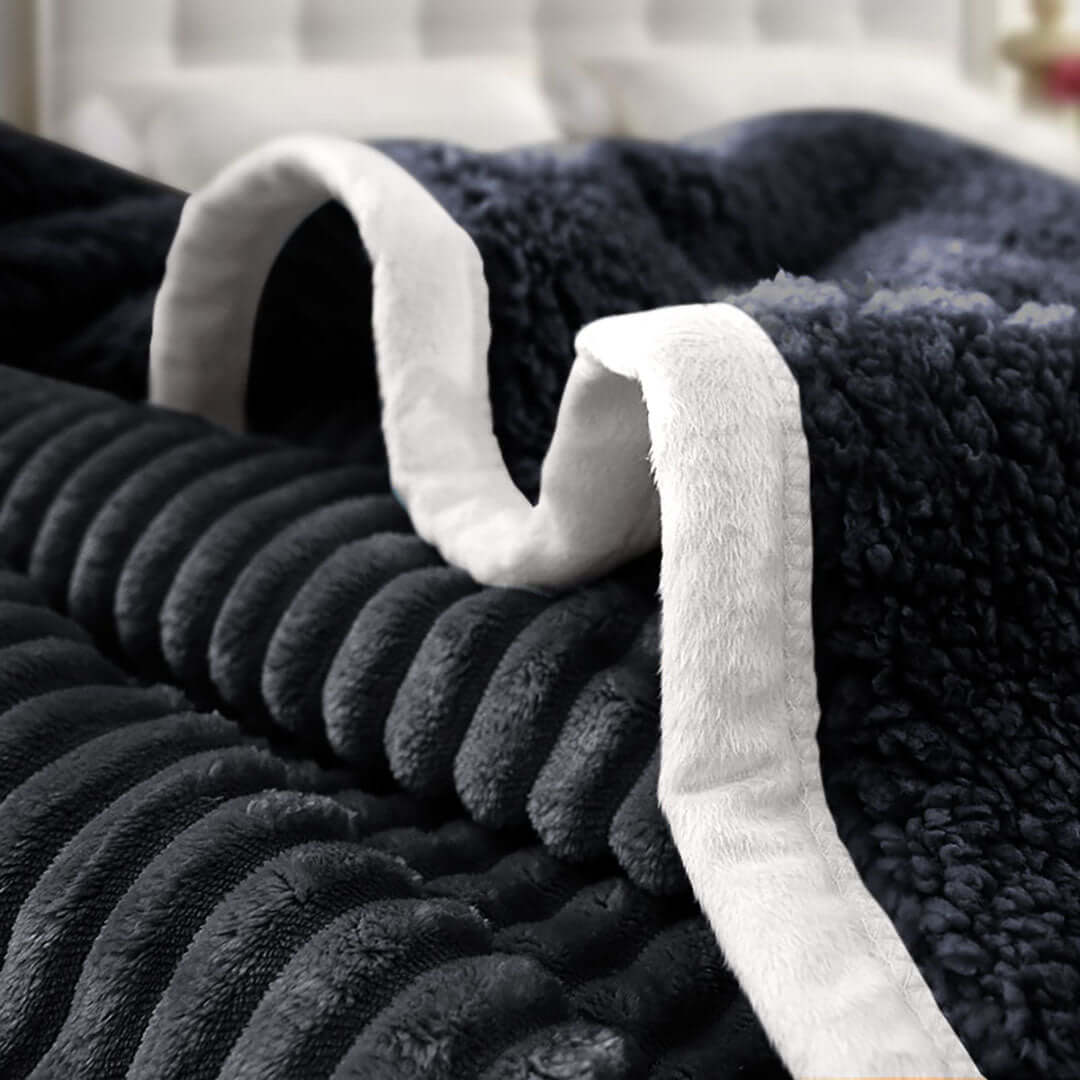 Luxurious black and white plush blanket, perfect for adding affordability, quality, and value to your homeware and furniture collection.