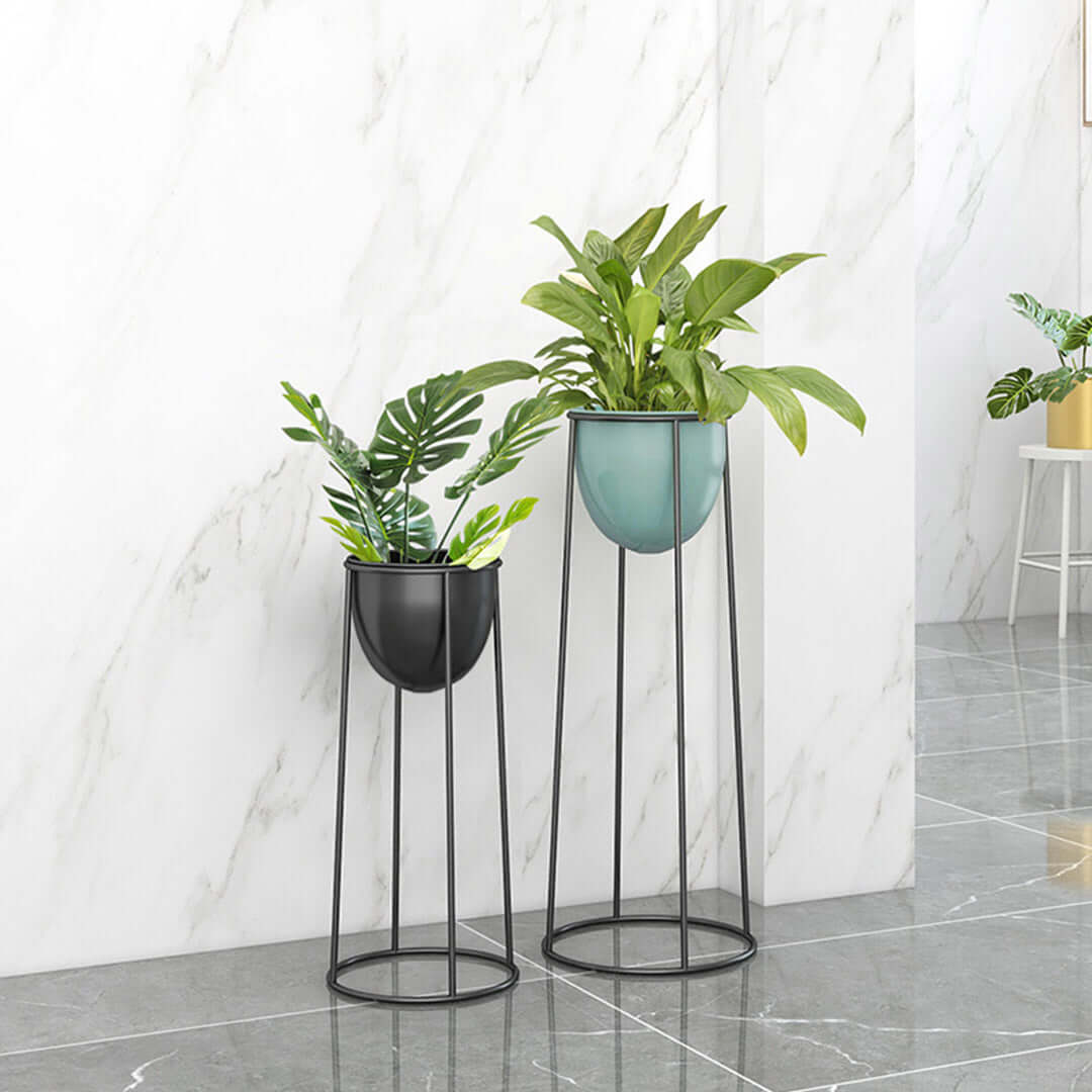 Affordable quality homewares - two value furniture tall metal plant stands with green plants.