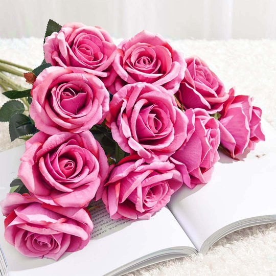 Bouquet of vibrant pink roses placed on an open book