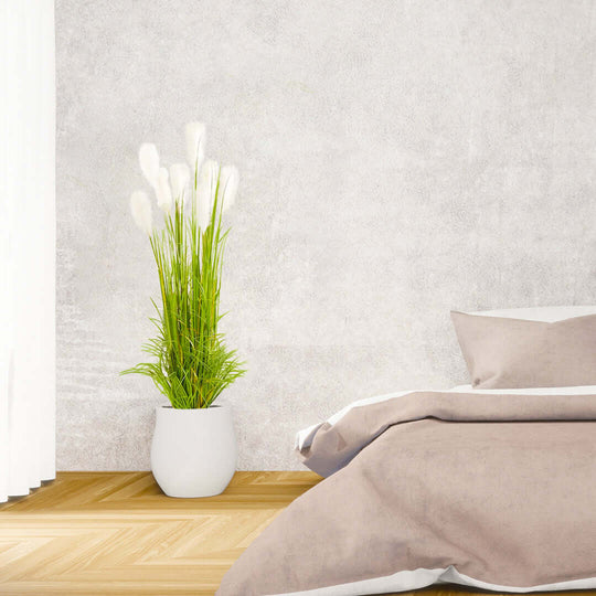 Affordable quality homewares - stylish bedroom decor with white vase and green plant beside a bed with neutral bedding. Value furniture essentials.