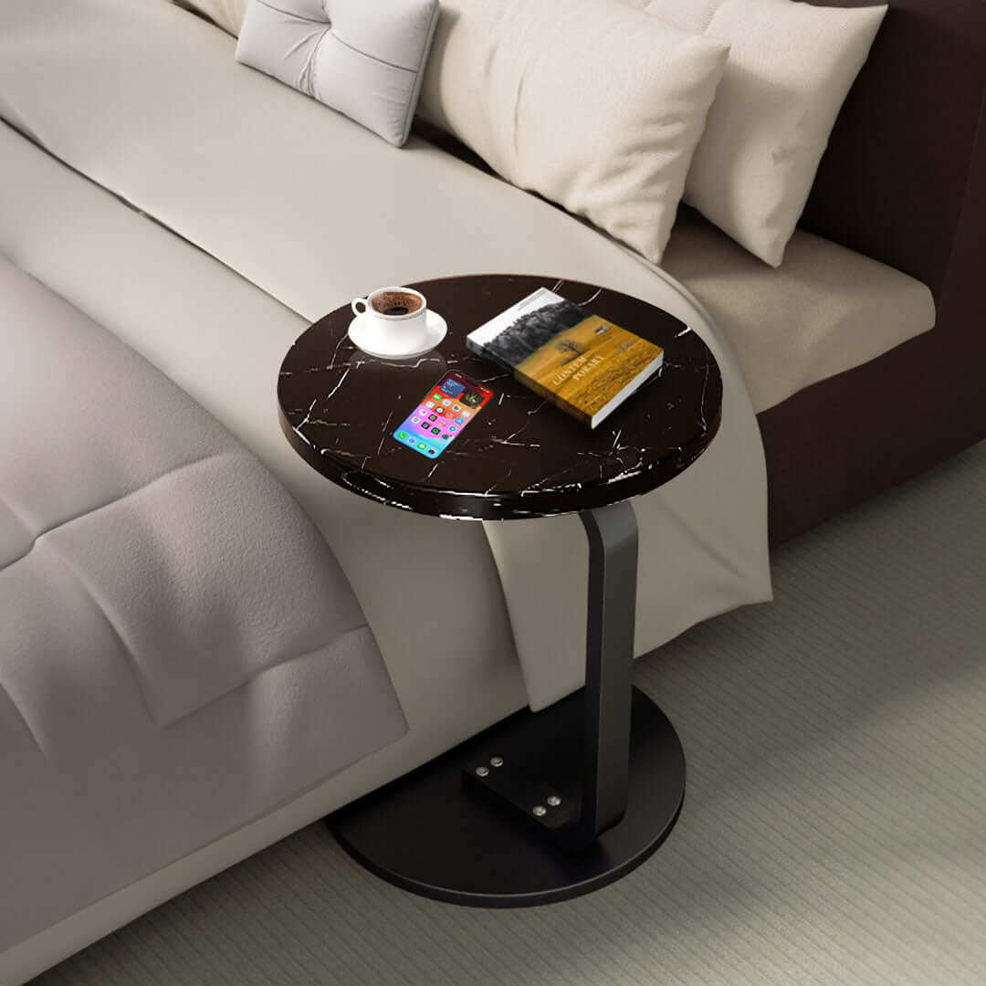 Stylish black marble side table beside bed with coffee, book, and smartphone - affordable, quality, and value homewares furniture.