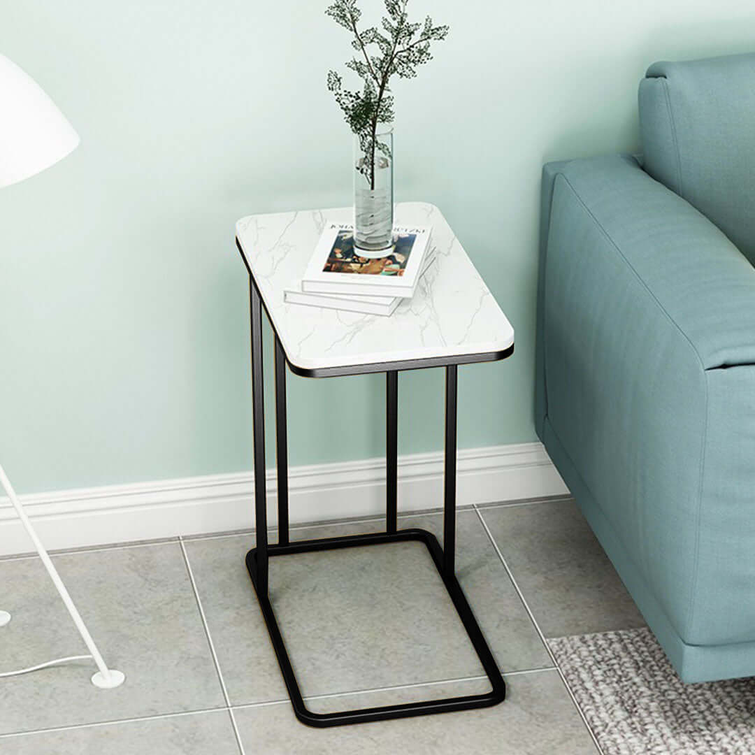 Affordable quality homewares side table with white marble top and black metal frame next to blue sofa, emphasizing value furniture options.