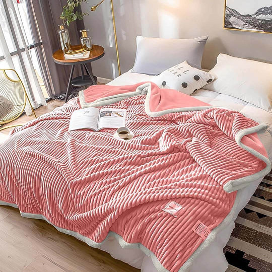 Luxurious pink and white ribbed blanket on a cozy bed, exemplifying affordable homewares and quality value furniture.